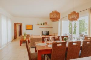 a dining room with a table and chairs with wine glasses at Villa Santo Tomás - Loli in Santo Tomás