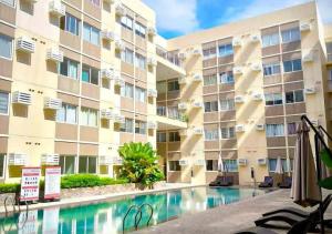 a swimming pool in front of a building at Prime Zen in Silang
