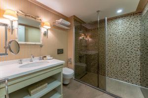 a bathroom with a sink and a shower at RuinAdalia Hotel in Antalya +77 photos