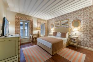 a bedroom with a bed and a television in it at RuinAdalia Hotel in Antalya