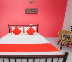 a bedroom with a bed with a red wall at Hotel Blue Mount View Kandy in Kandy +29 photos