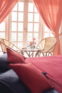 a room with a table and chairs and a bed at Hotel Blue Mount View Kandy in Kandy