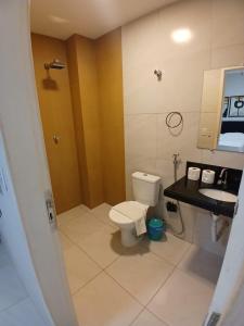 a bathroom with a toilet and a sink at Pousada Flat Lourdes Residence in Angicos +25 photos