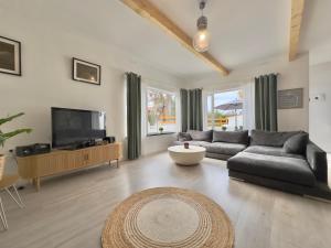 a living room with a couch and a tv at Chalet JULI Mirador in Puerto de la Cruz
