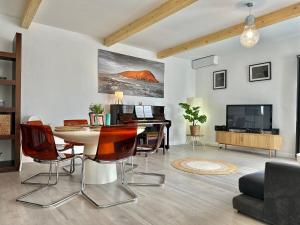 a living room with a table and a television at Chalet JULI Mirador in Puerto de la Cruz