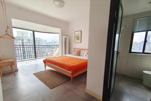 a bedroom with a bed and a balcony at Chihiro Haven in Chongqing