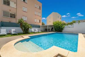 a swimming pool in front of a building at Ideal Property Mallorca - Christin in Cala Ratjada