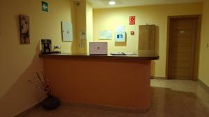 a bar in a hospital with a laptop on a counter at Ruralis Altozano in Montánchez