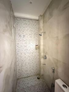 a bathroom with a shower and a toilet in it at Hotel Krishna Tulsi Van - Near Bankey Bihari & ISKCON in Vrindāvan +15 photos