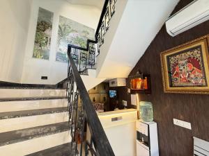 a staircase in a house with a painting on the wall at Hotel Krishna Tulsi Van - Near Bankey Bihari & ISKCON in Vrindāvan