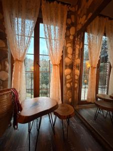 a room with a table and some windows at Loidevilla in Çamurlu