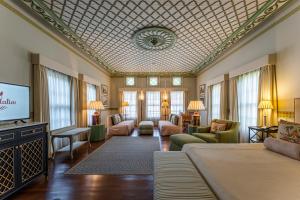 a living room with a couch and a tv at RuinAdalia Hotel in Antalya
