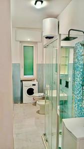 a white kitchen with a sink and a microwave at Brezza di Mar Ligure - casa vacanza in Borghetto Santo Spirito +17 photos