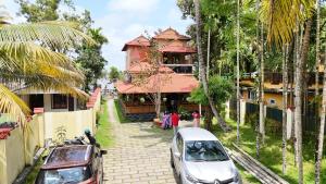 a building with a car parked in front of it at Atharvam Resort in Cherai Beach