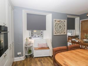 a kitchen and dining room with a table and chairs at The Wonky Nest in Windermere