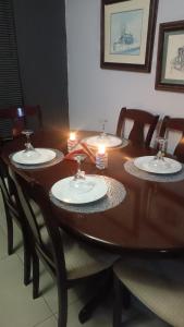 a wooden table with four plates on top of it at Bushman Kraal Lux in Soweto