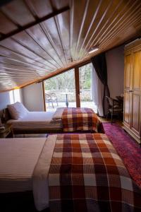 ein Schlafzimmer mit zwei Betten und einem großen Fenster in der Unterkunft loidevilla in Kemalpasa