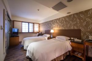 Ένα ή περισσότερα κρεβάτια σε δωμάτιο στο Delight Hotel