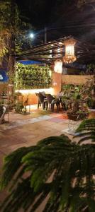 a group of benches in a patio at night at Bonsaiyog in Chapora