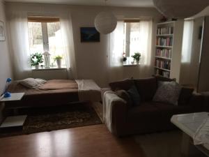 a living room with a bed and a couch at Lexe 2rok in Gävle