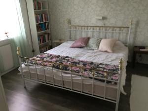 a bed with pillows and a blanket on it at Lexe 2rok in Gävle