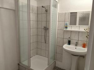 a bathroom with a shower and a sink at Levendula Vendégház in Ács