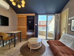 a living room with a couch and a table at Mina Boutique in Jerusalem
