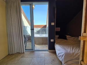 a bedroom with a bed and a view of a tub at Mina Boutique in Jerusalem