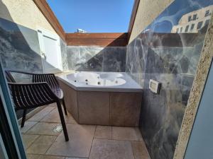 a bathroom with a sink and a chair in it at Mina Boutique in Jerusalem +30 photos