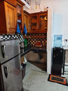 a kitchen with a refrigerator and a sink at bluemoonhiriketiya in Dickwella