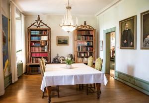 a dining room with a table and chairs at Hellidens Slott in Tidaholm