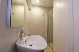 a bathroom with a white sink and a shower at Dimora Centro Storico in Sirolo
