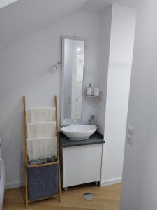 a bathroom with a white sink and a mirror at charnecas house in Gaula
