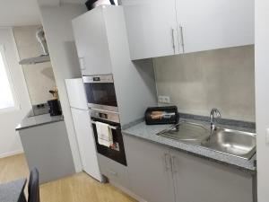 a small kitchen with a sink and a stove at charnecas house in Gaula