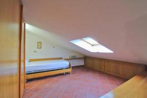 a bedroom with a bed and a skylight at Dimora Centro Storico in Sirolo