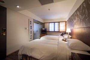 Ένα ή περισσότερα κρεβάτια σε δωμάτιο στο Delight Hotel