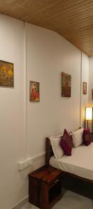 a white room with a bed and a table at Bonsaiyog in Chapora +48 photos