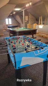 a pool table in a room with two tables at Dom na Ubocy in Groń