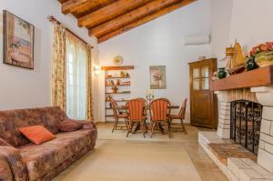 a living room with a couch and a fireplace at Holiday Apartment Maria in Orebić