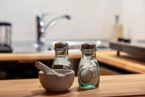 two glass bottles and a bowl on a counter at Das Juwel in Erbach +23 photos