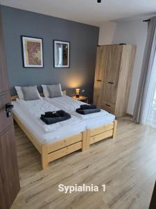 a bedroom with a large bed with two pillows on it at Dom na Ubocy in Groń