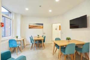 a meeting room with tables and chairs and a flat screen tv at Haus Antina - App 2 in Borkum