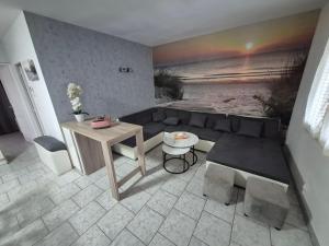 a living room with a couch and a table at Gîte OL'HERON familiale pour 9 personnes à Dolus in Dolus-d'Oléron