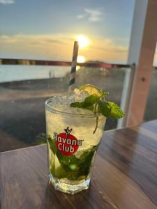 a drink sitting on a table with a lime and a straw at Casa Pavon in Montaña Alta