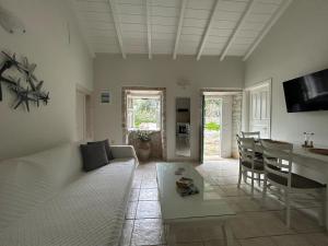 a living room with a couch and a table at Loukas house Paxos in Boïkátika