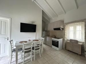 a kitchen with a table and chairs in a room at Loukas house Paxos in Boïkátika