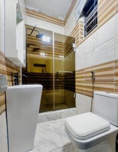 a bathroom with a toilet and a shower at Msb LUXURY HOME in Lekki