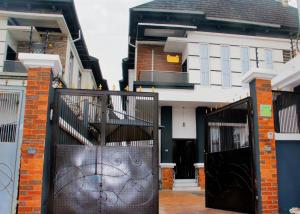 a pair of wrought iron gates in front of a house at Msb LUXURY HOME in Lekki