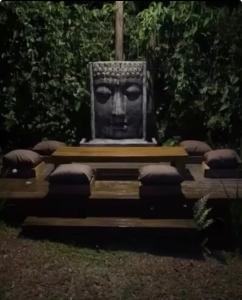 a statue of a head sitting in a park at Quinta Di Crivelli in Praia do Rosa
