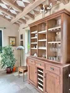 a large wooden cabinet with wine glasses in it at Private Villa for 12 Peaceful Karst Escape in Dutovlje +80 photos